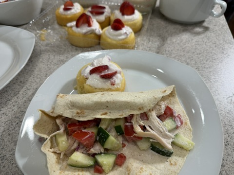 Chicken street wrap served with fresh vegetables and a strawberry dessert