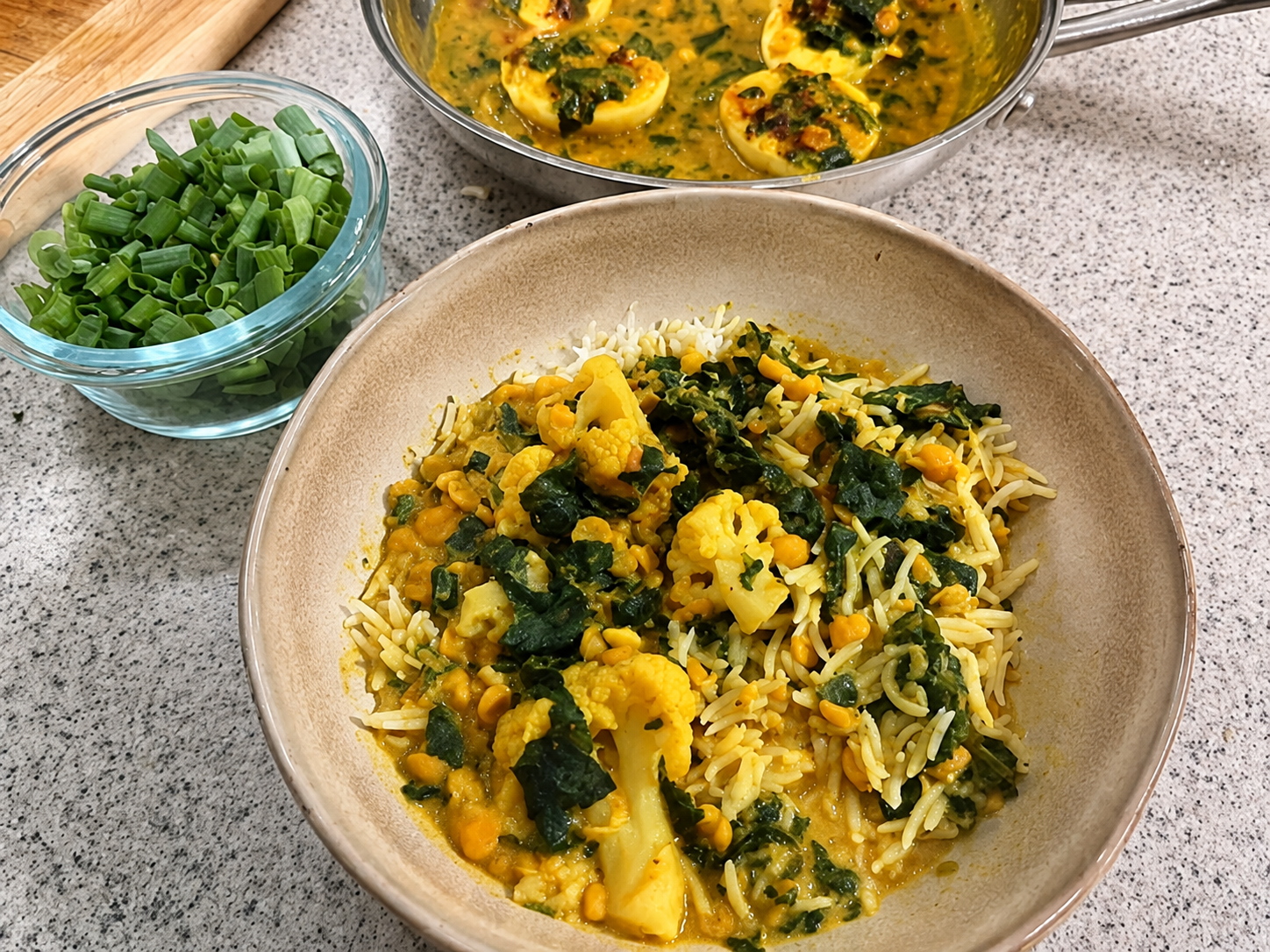 Creamy coconut dal with spinach and cauliflower served over rice