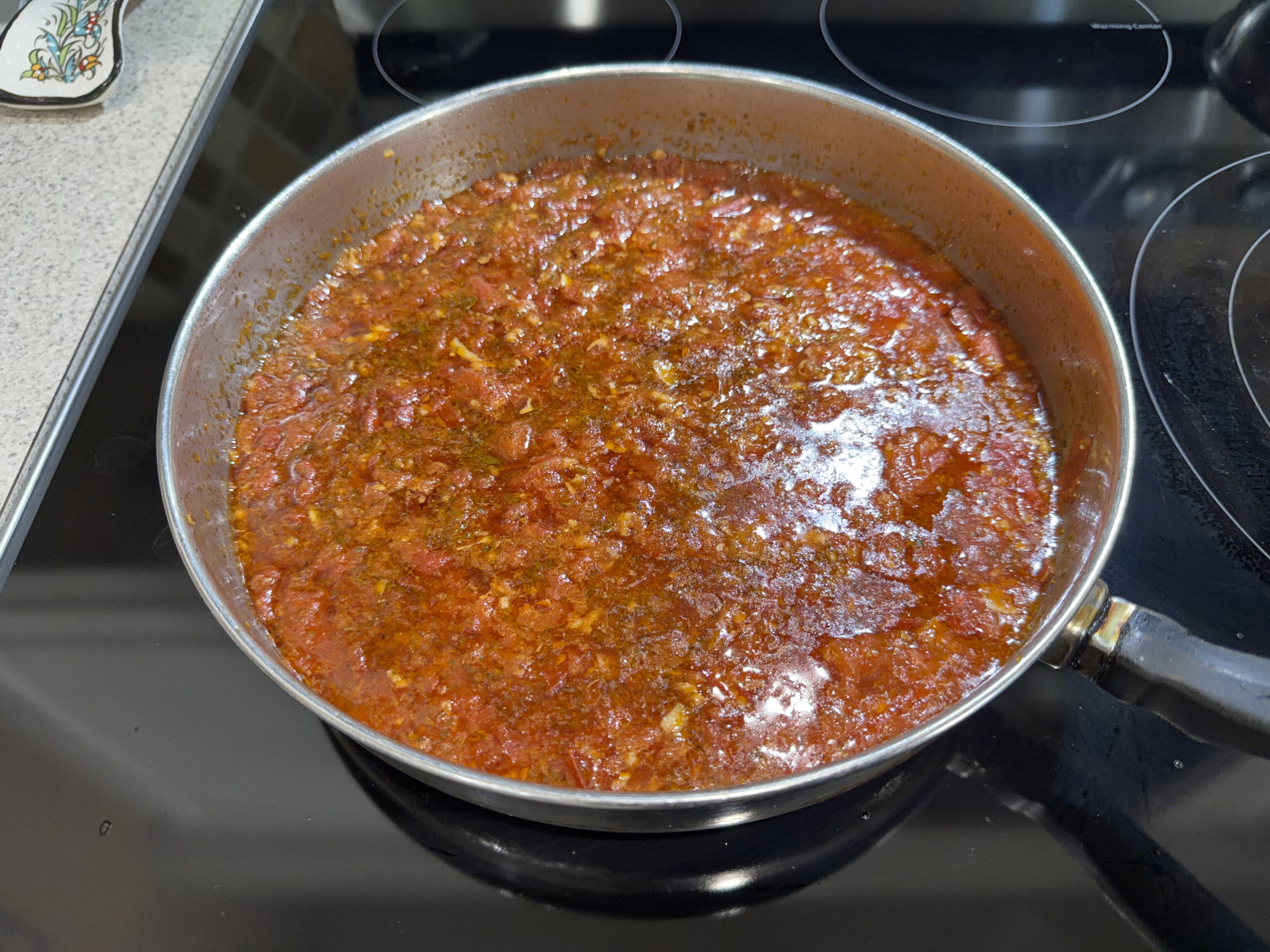 Fresh chunky marinara sauce simmering in a pan