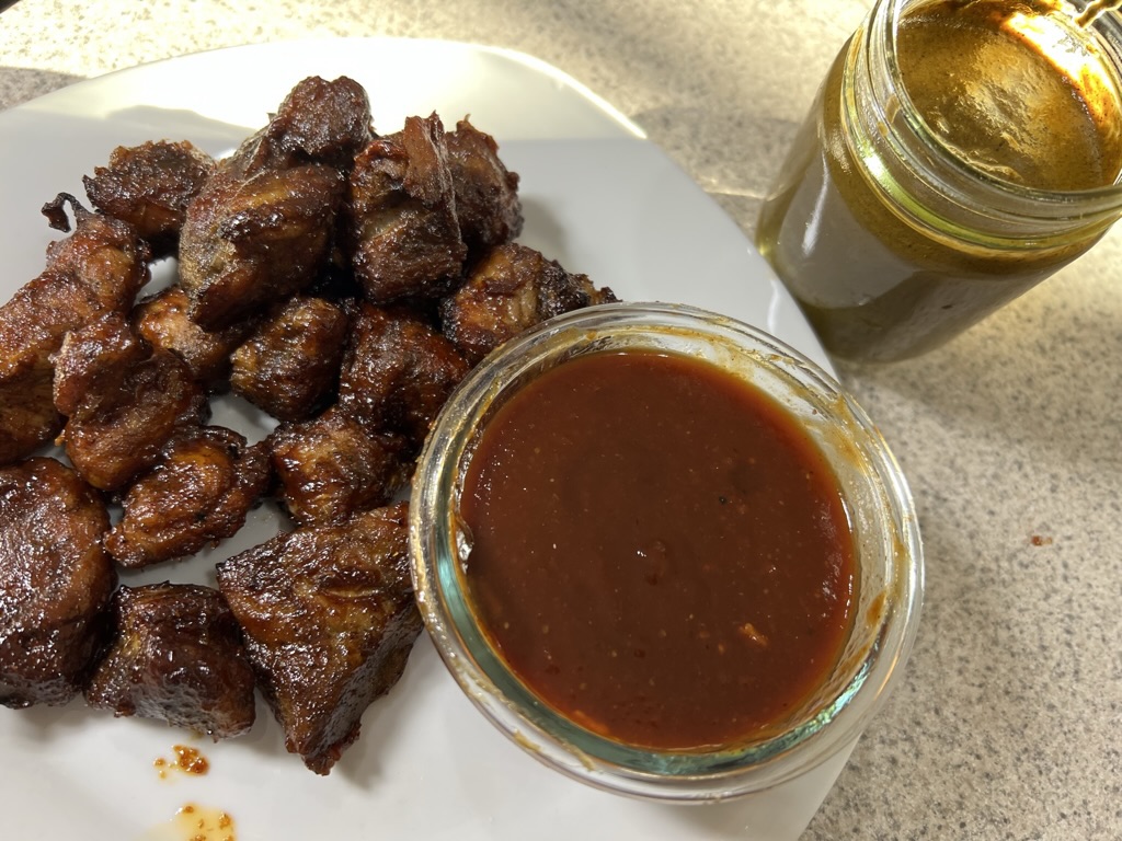 Homemade barbecue sauce served with glazed meat