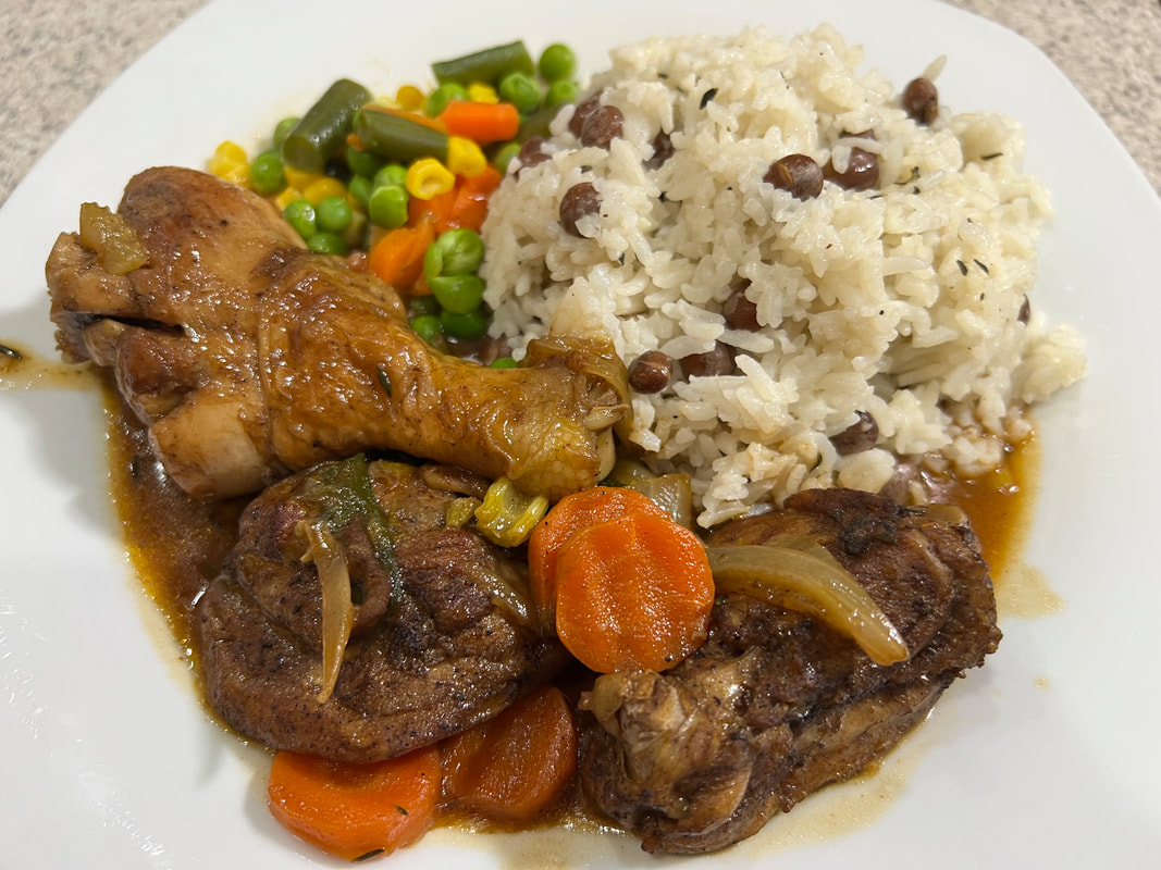 Dianne's Jamaican brown stew chicken served with rice and peas and vegetables