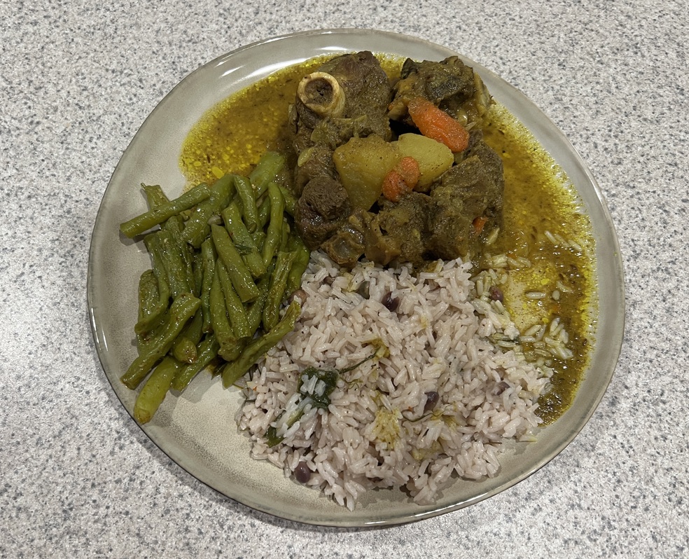 Dianne's Jamaican curry goat served with rice and peas and green beans