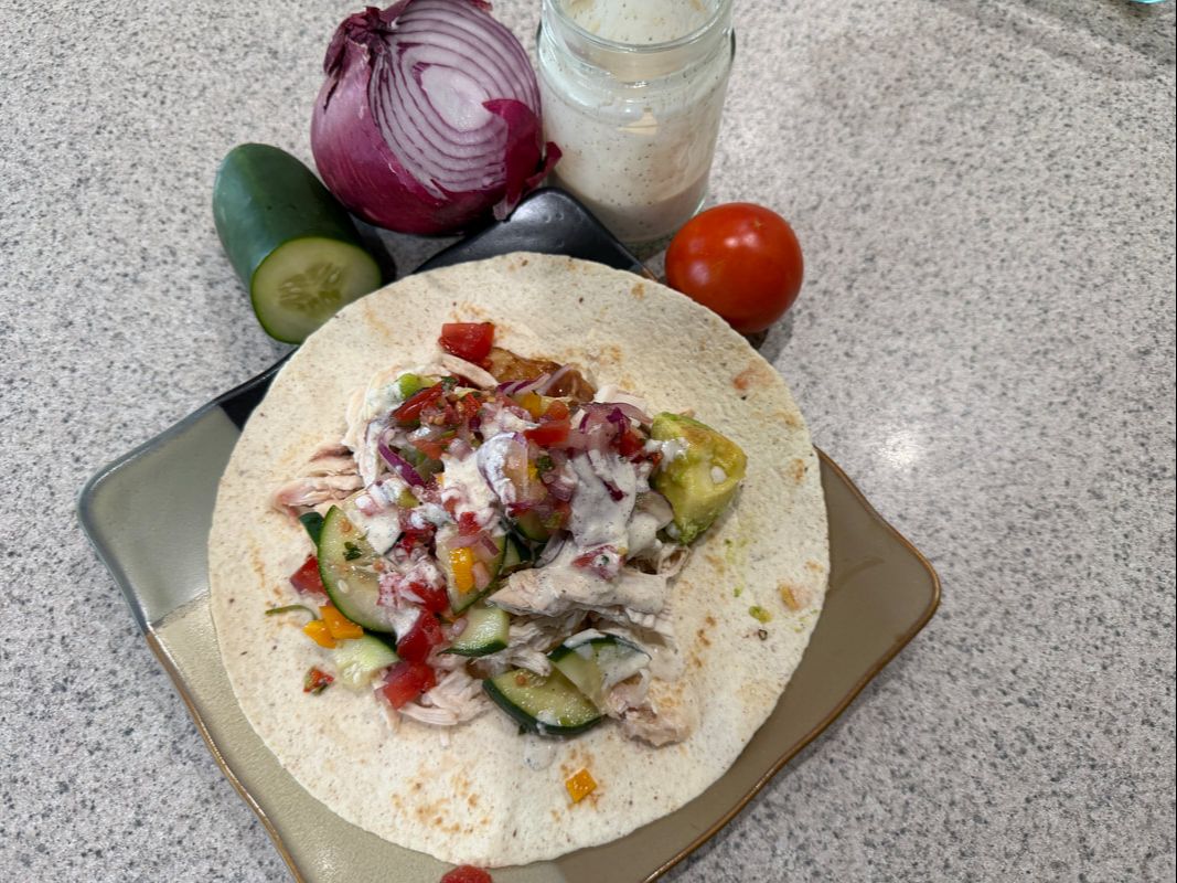 Chicken street wrap with fresh vegetables and creamy dressing